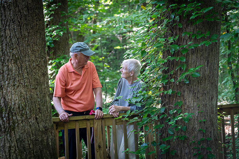 Older couple looking at each other on nature trail | Presbyterian Village Austell