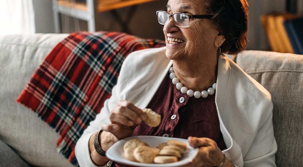 A senior woman enjoys a meal